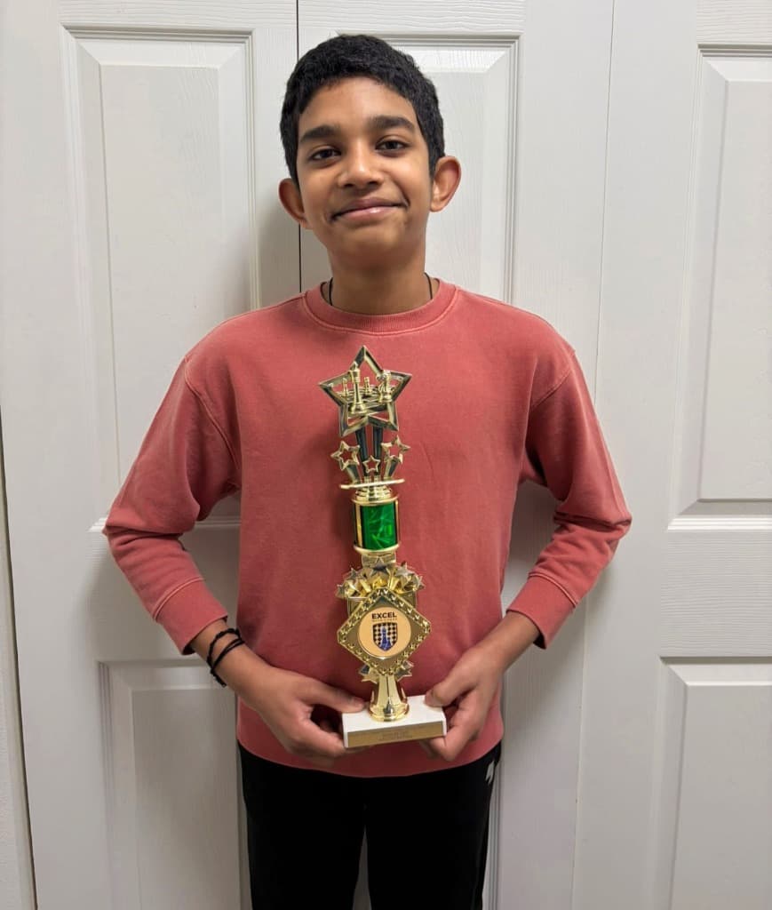 Venkata Sai Akshar Mirthipati holding his 3rd place trophy at Excel with Chess Washington State Qualifier chess tournament